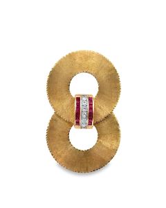 14K Gold Retro Diamond Double Circle Brooch centrally set with 6 diamonds weighing approx. .30Cts, framed with 14 square cut rubies weighing .70cts, 16Dwt/25Gr., measuring 2 3/4 inches in length. 